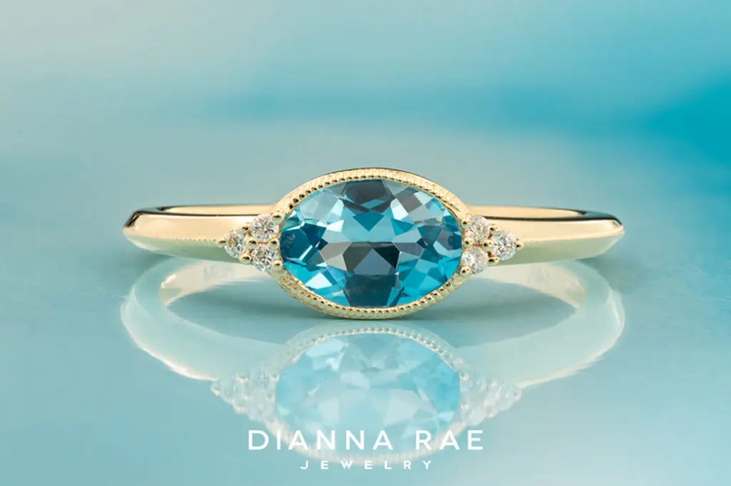 14K Yellow Gold Oval Blue Topaz with Diamond Side Stones