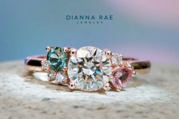 Lotus - Rose Gold Round Diamond Asymmetrical Engagement Ring with Montana Sapphire and Lotus Garnet Accents