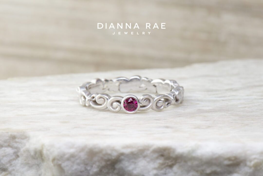 White Gold Scroll Band with Bezel Set Ruby