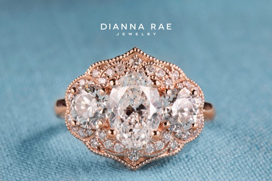 Rose Gold Three Stone Oval Diamond Halo Engagement Ring with Diamond Accents