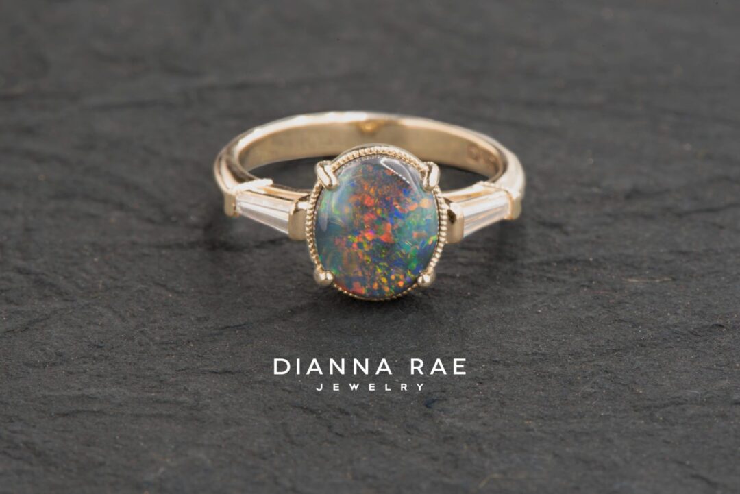 Yellow Gold Oval Black Opal Classic Three Stone Ring with Diamond Baguettes