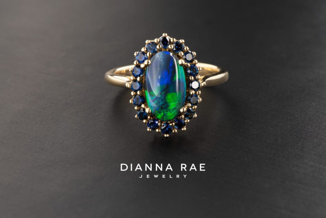 Yellow Gold Oval Black Opal Cluster Halo Cocktail Ring with Blue Sapphire Accents