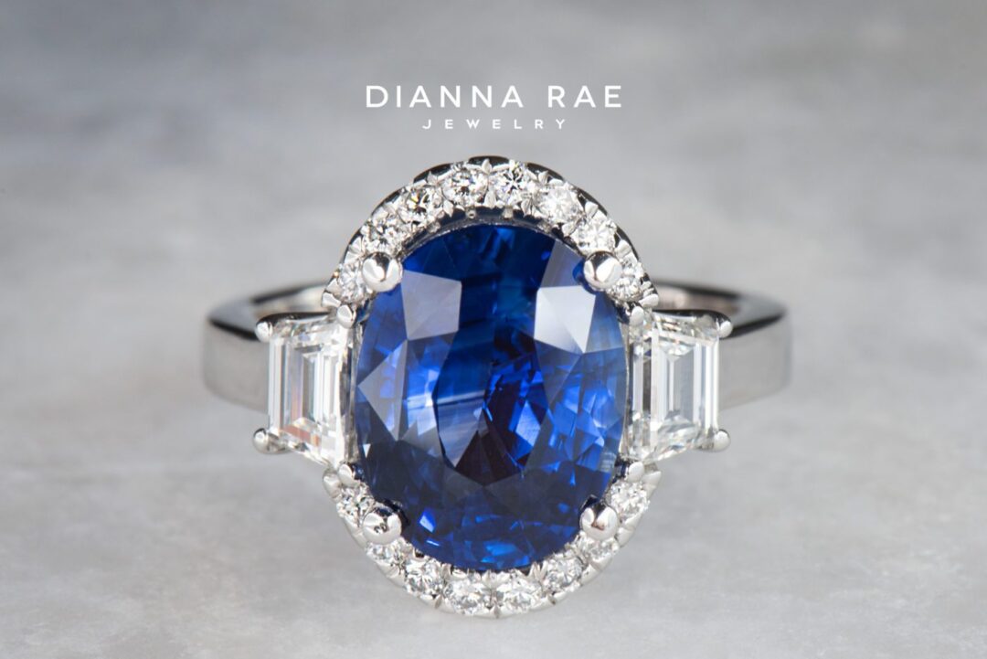 Platinum Oval Blue Sapphire Halo Cocktail Ring with Round and Trapezoid Diamond Accents