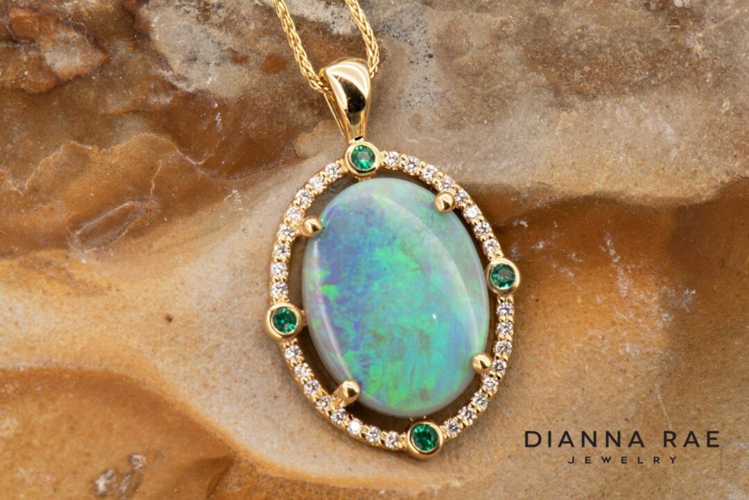 Yellow Gold Oval Opal Pendant with Emerald and Diamond Halo - Image 2