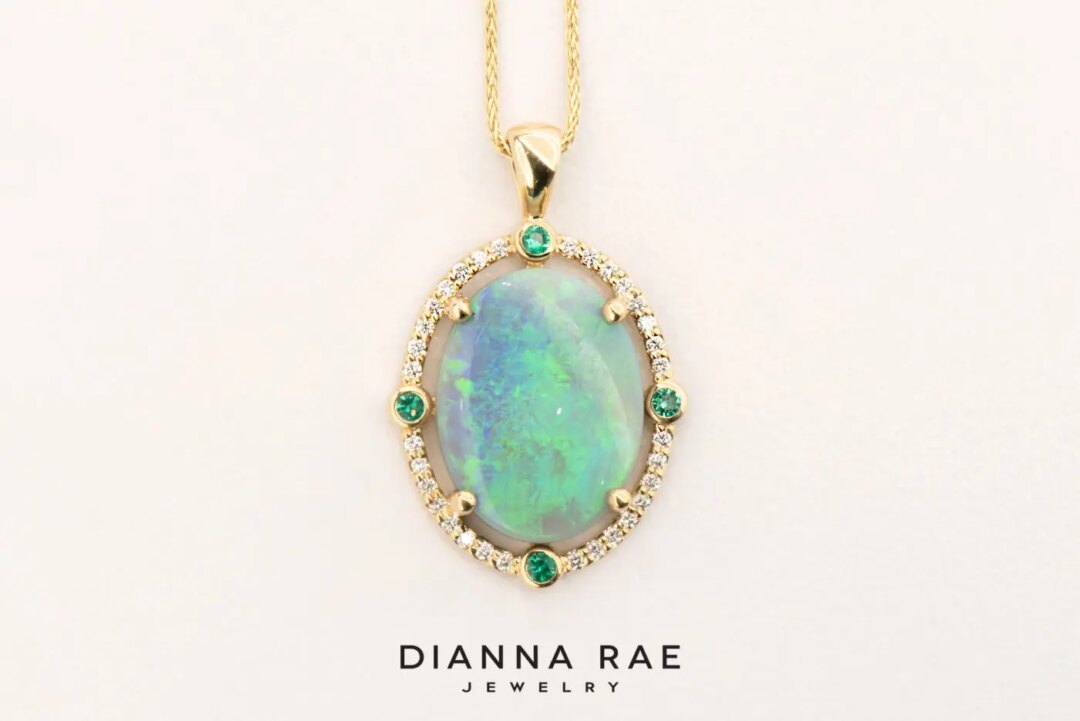 Yellow Gold Oval Opal Pendant with Emerald and Diamond Halo