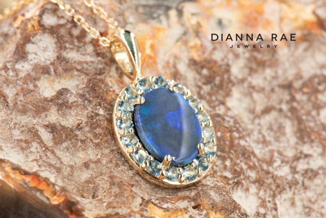 Yellow Gold Oval Black Opal Pendant with Aquamarine Halo - Image 2
