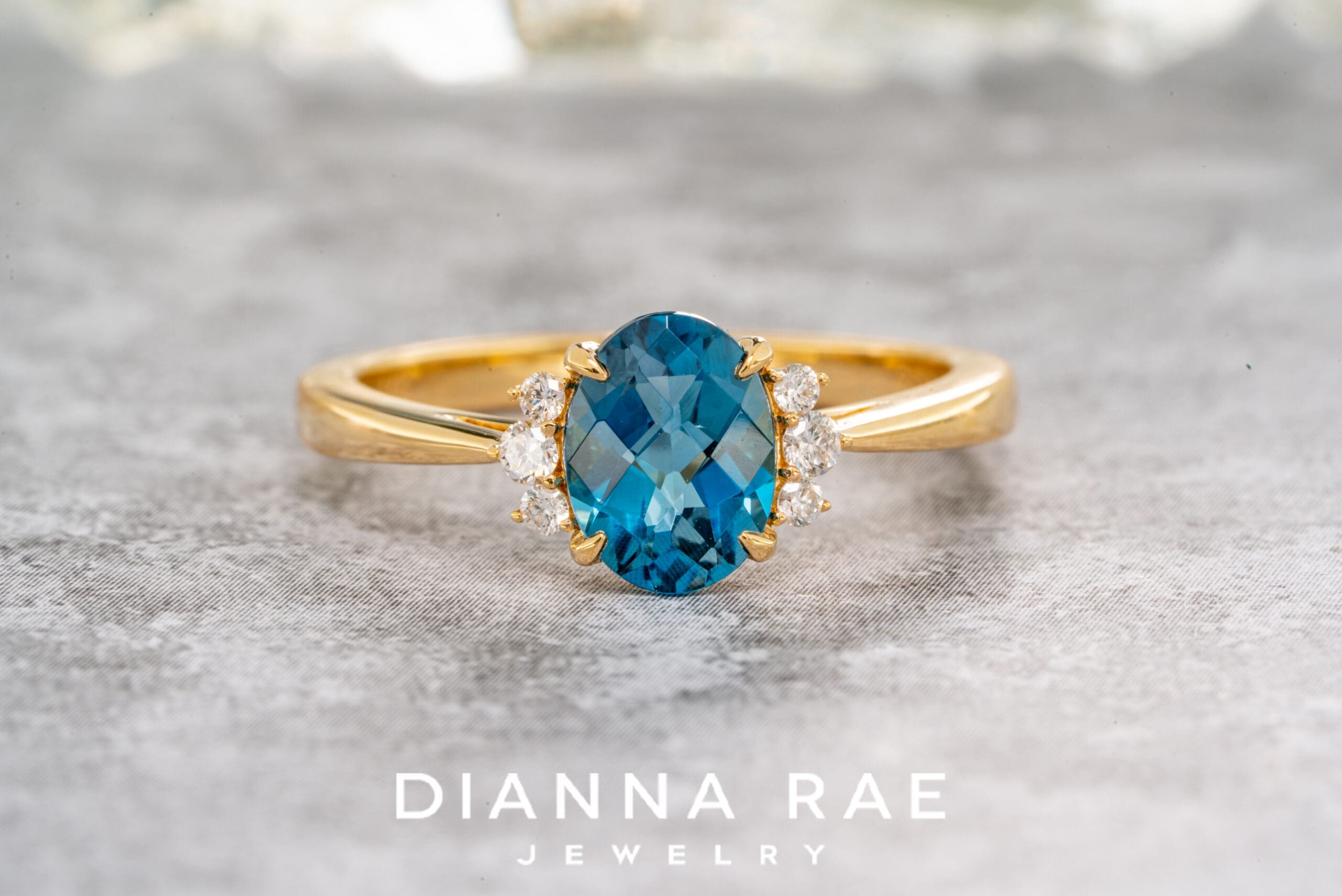 14K Yellow Gold Oval Blue Topaz Ring with Diamond Accents