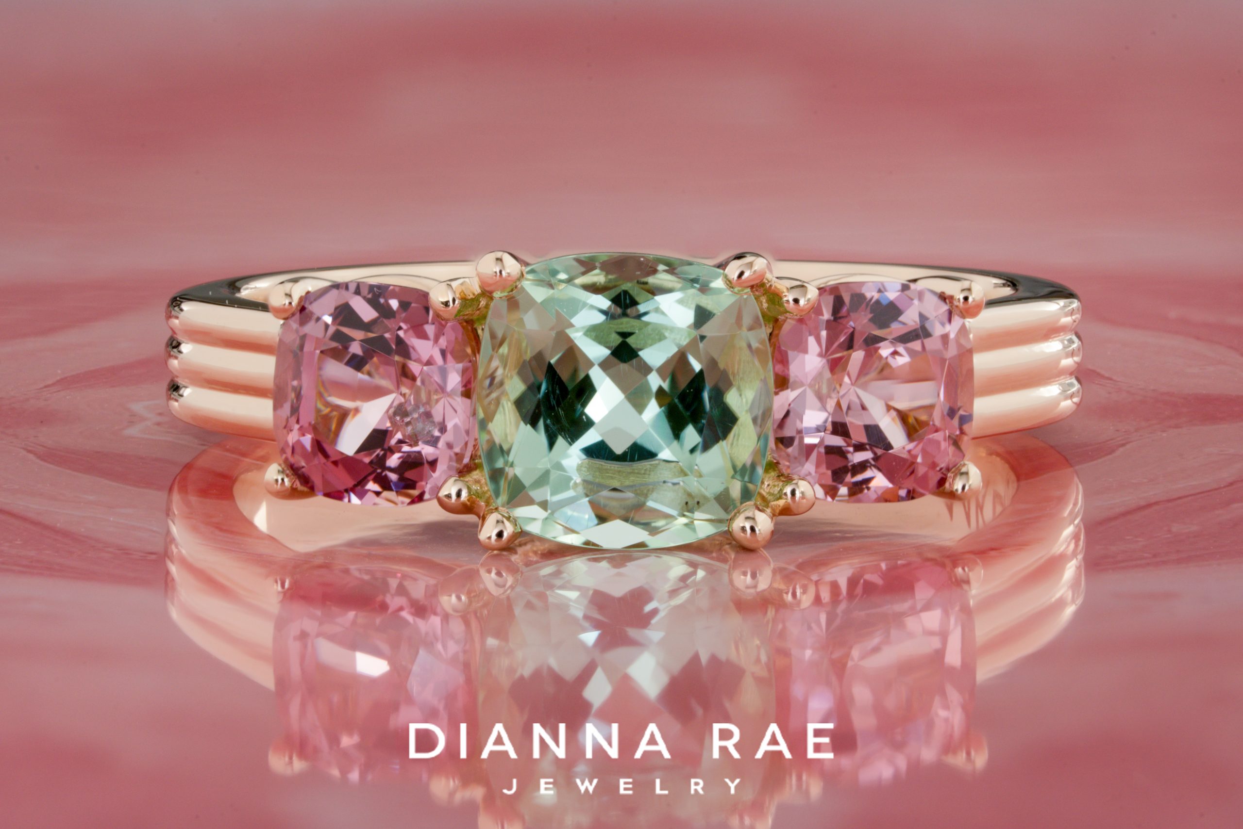 Green Tourmaline Ring with Pink Garnet Side Stones