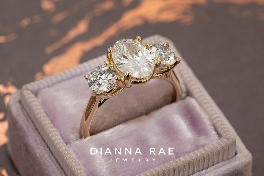 Oval Diamond Ring with Round Diamond accents on 14K Yellow Gold