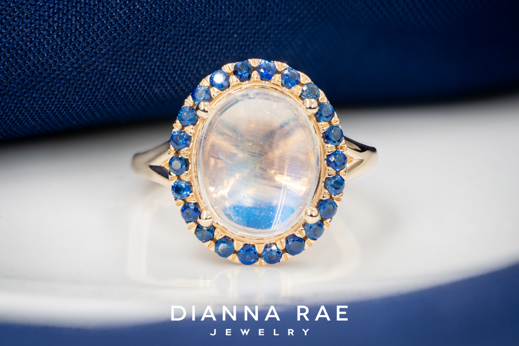 Yellow Gold Cabochon Moonstone Ring with Sapphire Halo