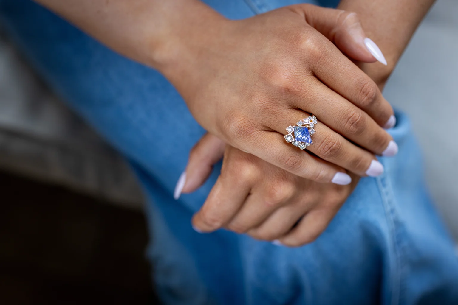 Blue gemstone statement ring and bracelet worn with a white button-down shirt - Dianna Rae Jewelry